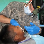 DOD photo by Donna Miles | Army Col. (Dr.) Jeff Young from the 133rd Medical Company in Colorado extracts a tooth from a young Guatemalan boy as part of Beyond the Horizon 2012, June 27, 2010. 