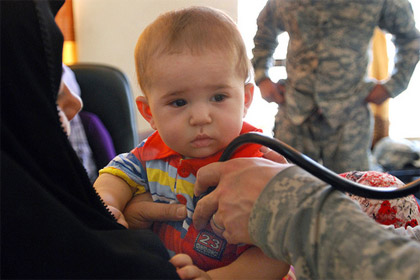 U.S. Army photo by Sgt. 1st Class Joe Thompson | U.S. Army Capt. Jason Smith listens to an infant’s breathing at the last “Bring on the Docs” cooperative medical engagement at Jassan Health Clinic in Wasit province, Iraq, June 23, 2009.