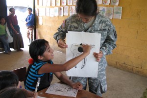 DOD photo by Donna Miles  | Army Capt. Gloria Graham, a 352nd Combat Support Hospital, teaches a Guatemalan girl how to properly brush her teeth during a five-day medical readiness training exercise in Pocola, Guatemala, as part of Beyond the Horizon 2012, June 27, 2010.