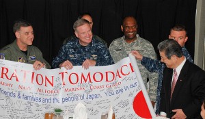 U.S. Navy photo by Petty Officer 3rd Class Kyle Carlstrom | Japanese Defense Minister Toshimi Kitazawa views a banner created by U.S. service members in honor of Operation Tomodachi during his visit to the USS Ronald Reagan, April 4, 2011. Among those holding the banner are Army Lt. Gen. Burton Field, commander of U.S. Forces Japan, and U.S. Pacific Fleet Commander Navy Adm. Patrick Walsh.