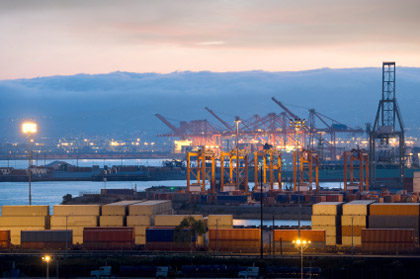 © iStockphoto.com/kevinjeon00 | Industrial harbor with cranes and cargo containers.
