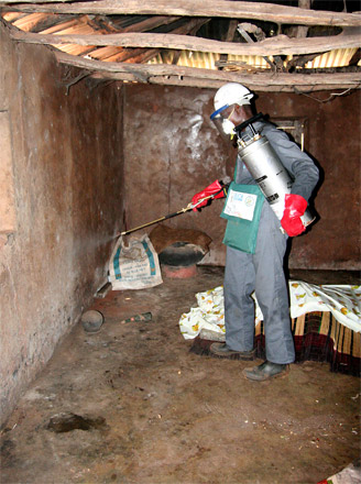 Photo by Nathan Miller, USAID/Benin|African Insecticide Residential Spray Campaign operator spraying house walls for malaria.