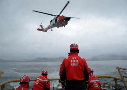 U.S. Coast Guard photo by Petty Officer 3rd Class David Paquine | Coast Guard Cutter Liberty prepares to receive a trail line from a Sitka-based Coast Guard air station MH-60 Jayhawk helicopter crew during a hoist training evolution in Sitka Sound, April 1, 2011.